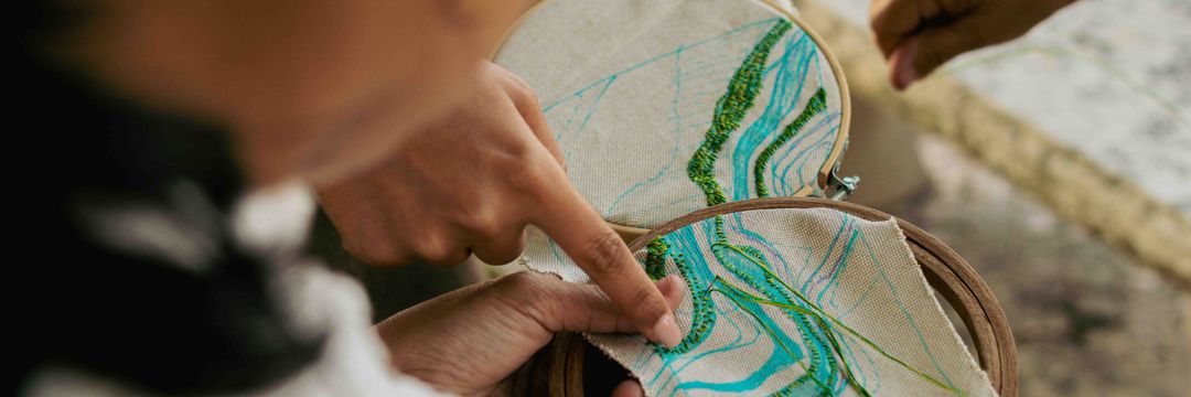 Embroidered maps as critique of cartographic power